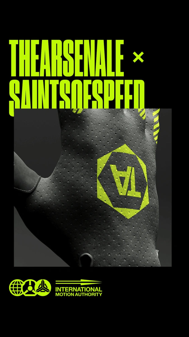 Collaboration BMX bike gloves by TheArsenale and Saints of Speed, featuring perforated black fabric and bold neon yellow branding.