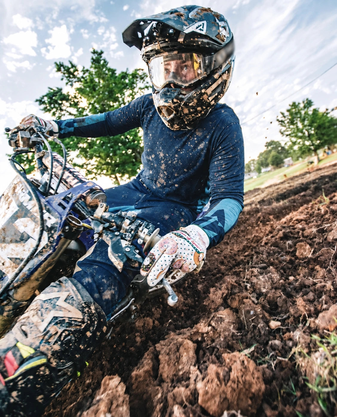 Motocross rider wearing Saints of Speed gloves