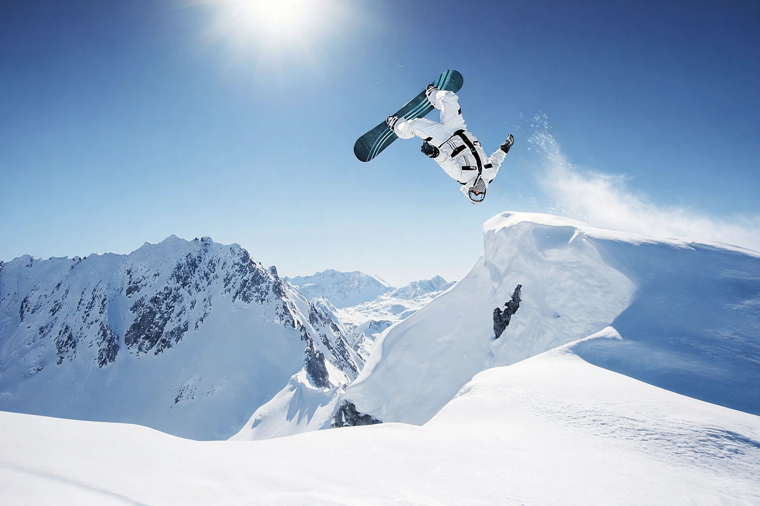 Snowboarder above a snowy mountain ridge