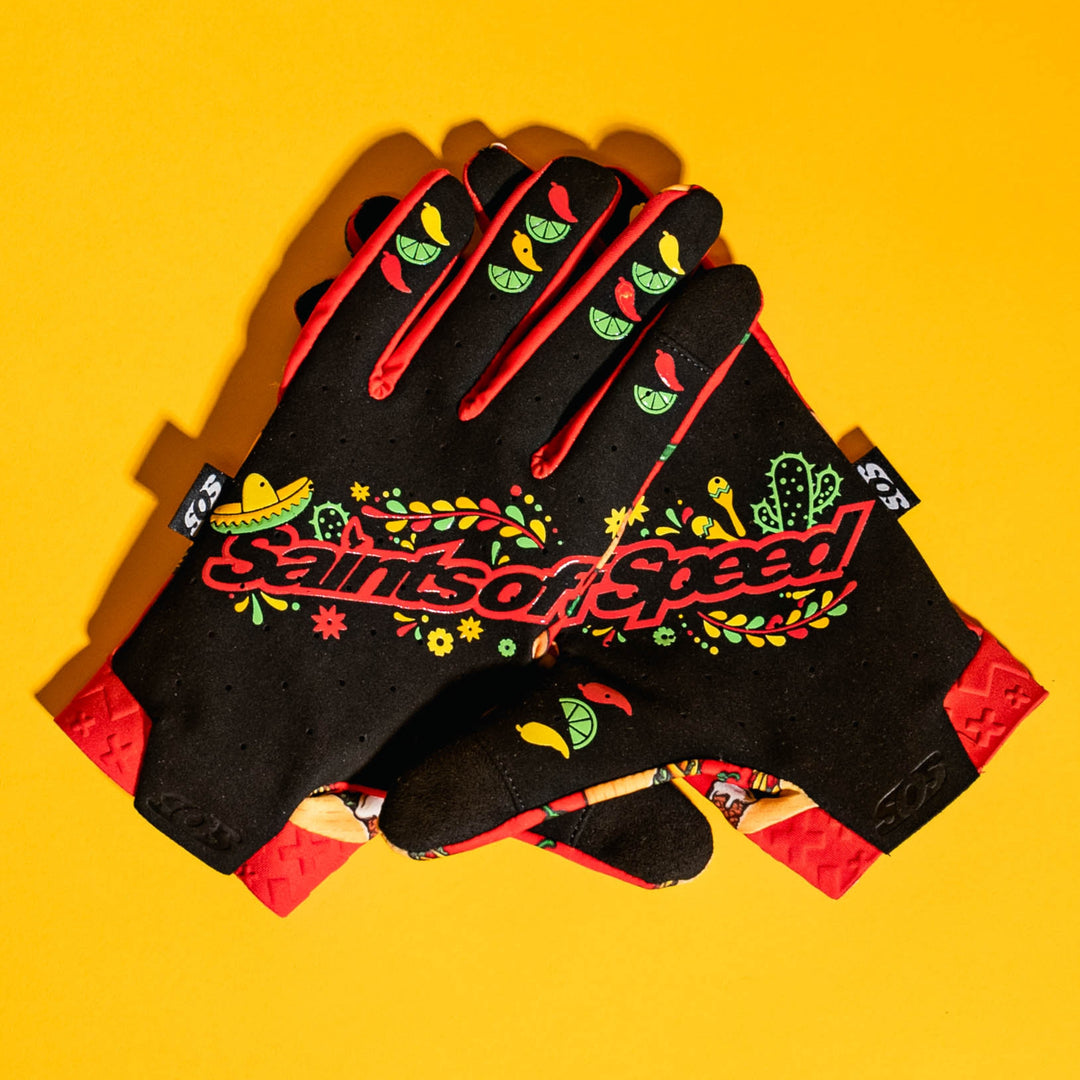 Saints of Speed floral riding gloves on a bright yellow background